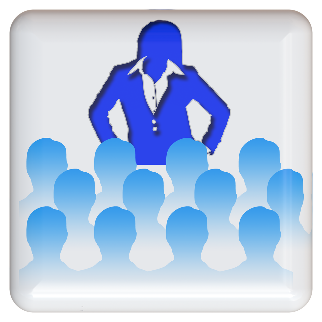 image of woman in blue blazer, teaching a presentation to mixed audience