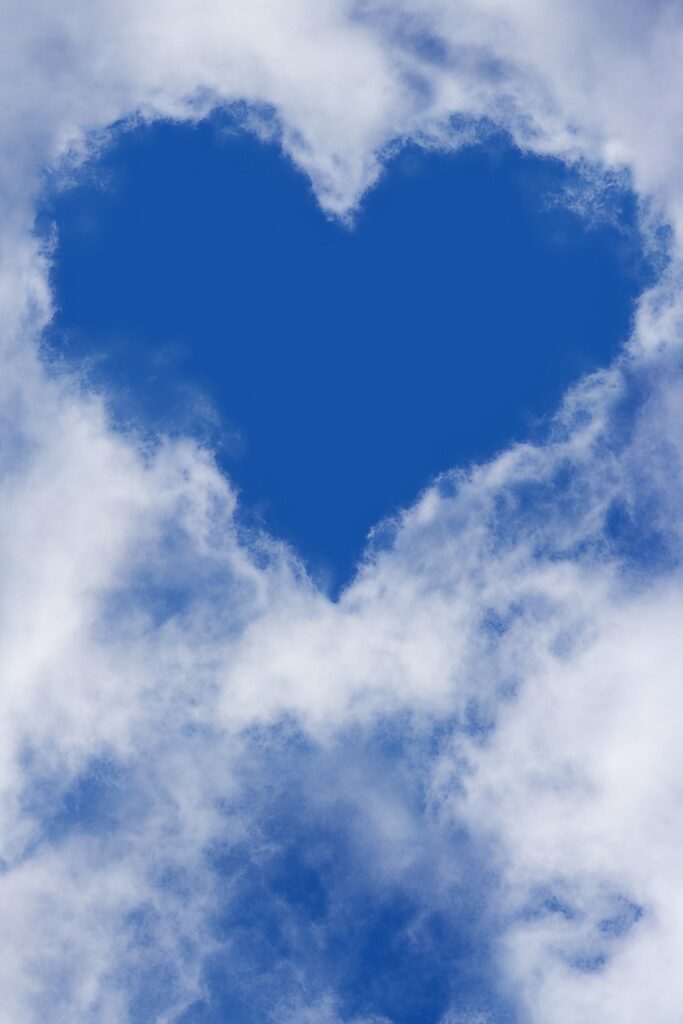 blue heart within white clouds, representing love