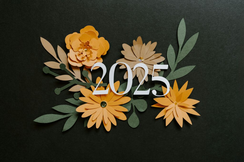 2025 black background with flowers in gold and green leaves