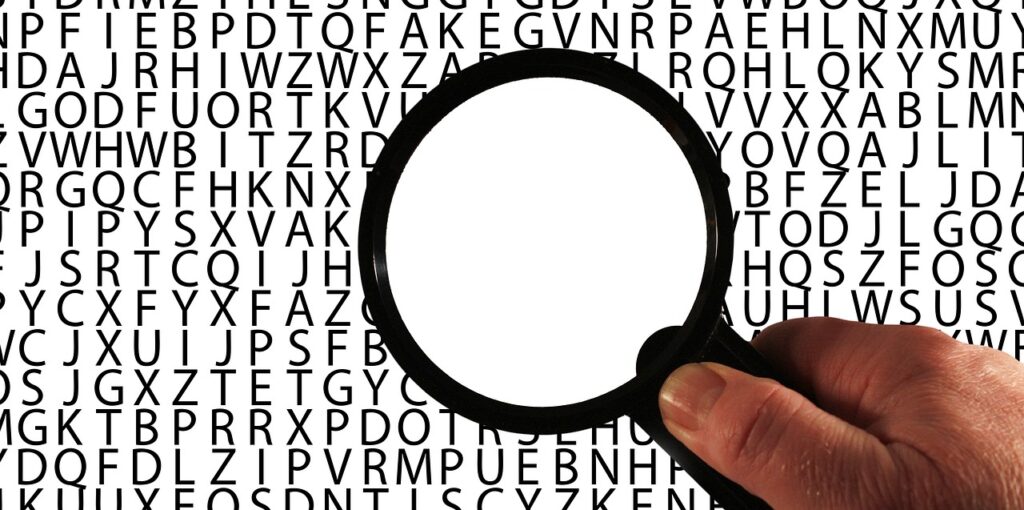 magnifying glass - words black and white letters with magnifying glass