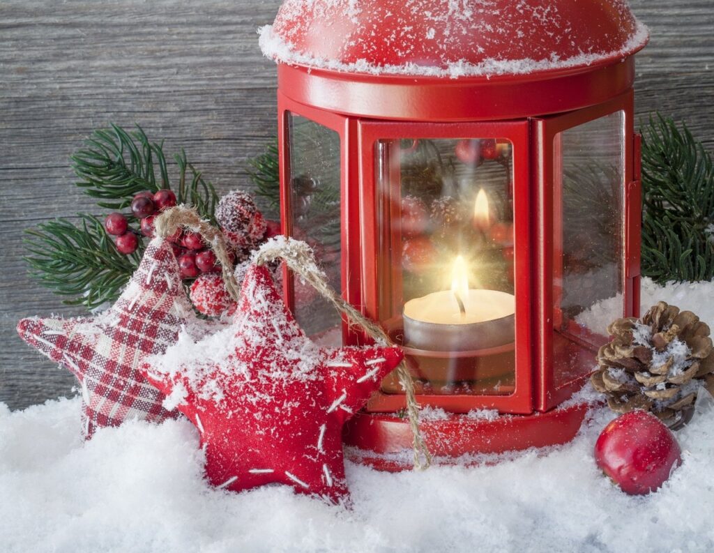 Xmas lantern red lantern with gingham stars, pine cone, on a bed of snow