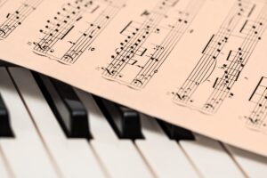stevepb-piano-1655558 piece of music places on piano keyboard