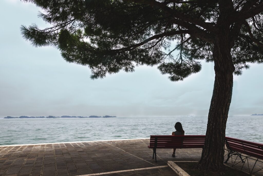 woman sitting by lake - in the silence